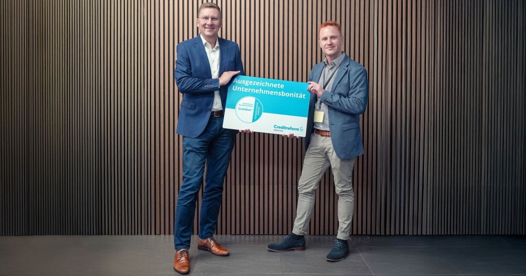 Ein Repräsentant von Creditreform übergibt symbolisch das Bonitätszertifikat CrefoZert an Klaus Lüttikhuis, den CFO von GGM Gastro.